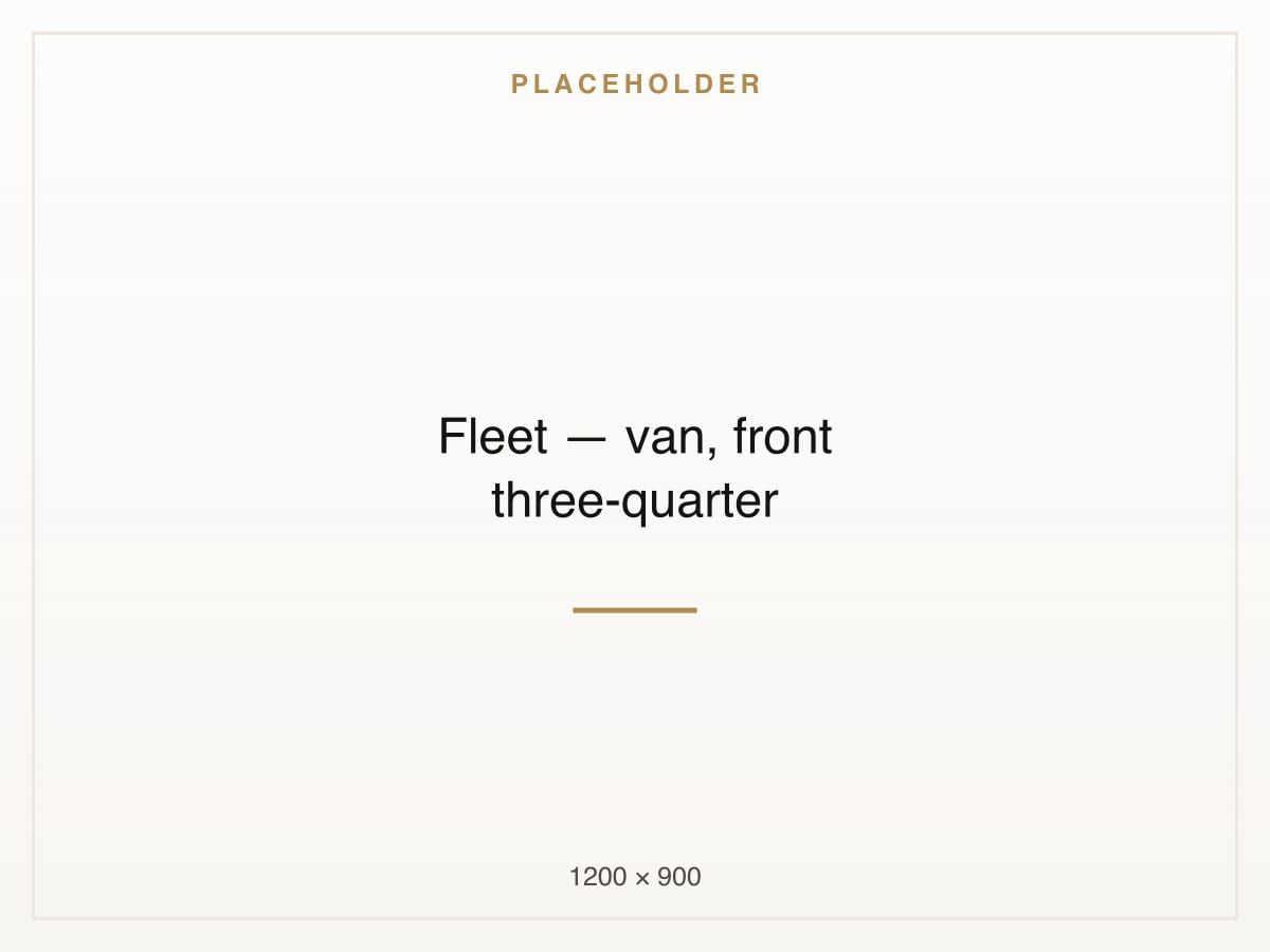 A white passenger van photographed from the front three-quarter angle.