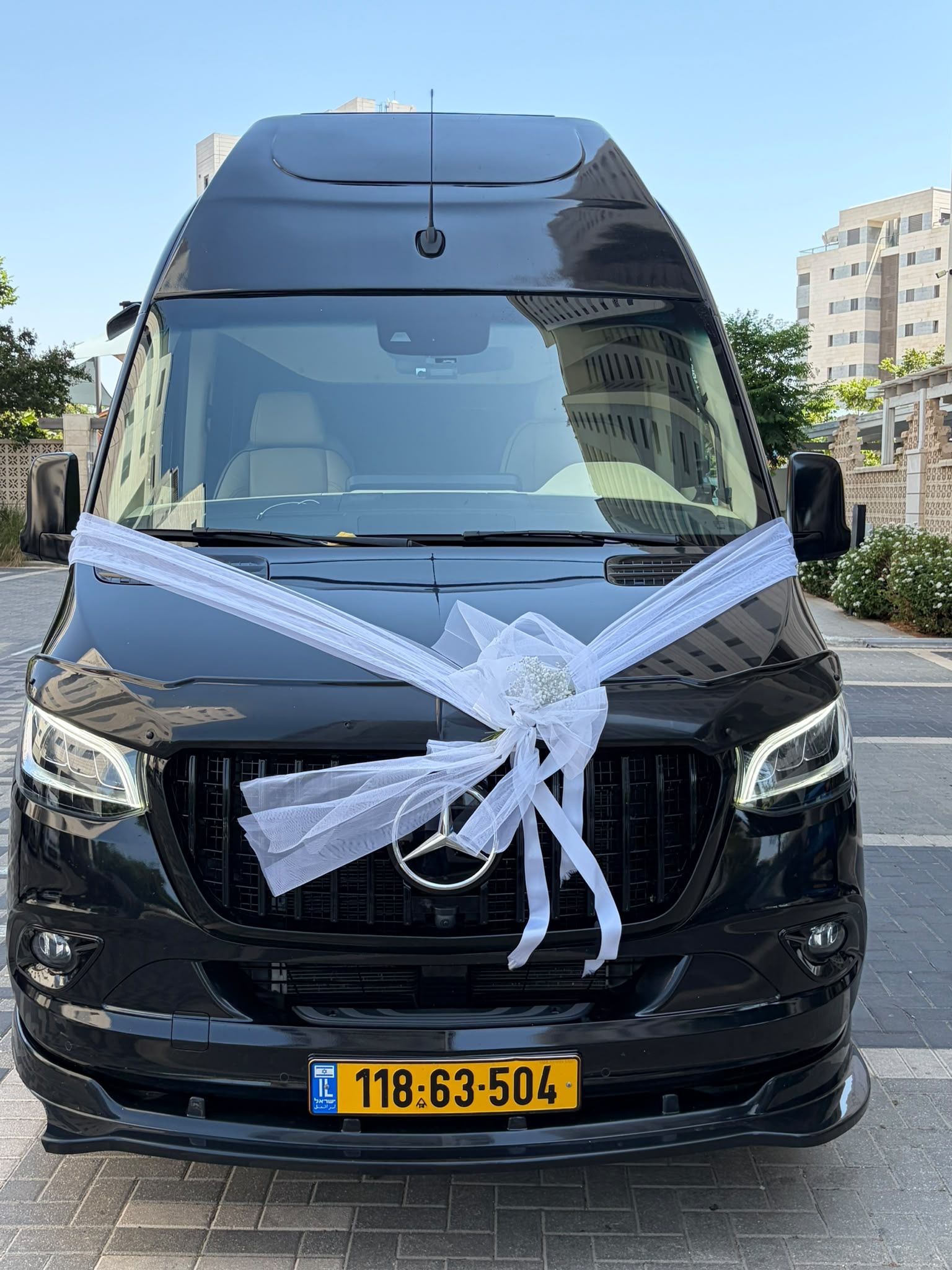 פפיון טול לבן קשור לרכב חתונה.